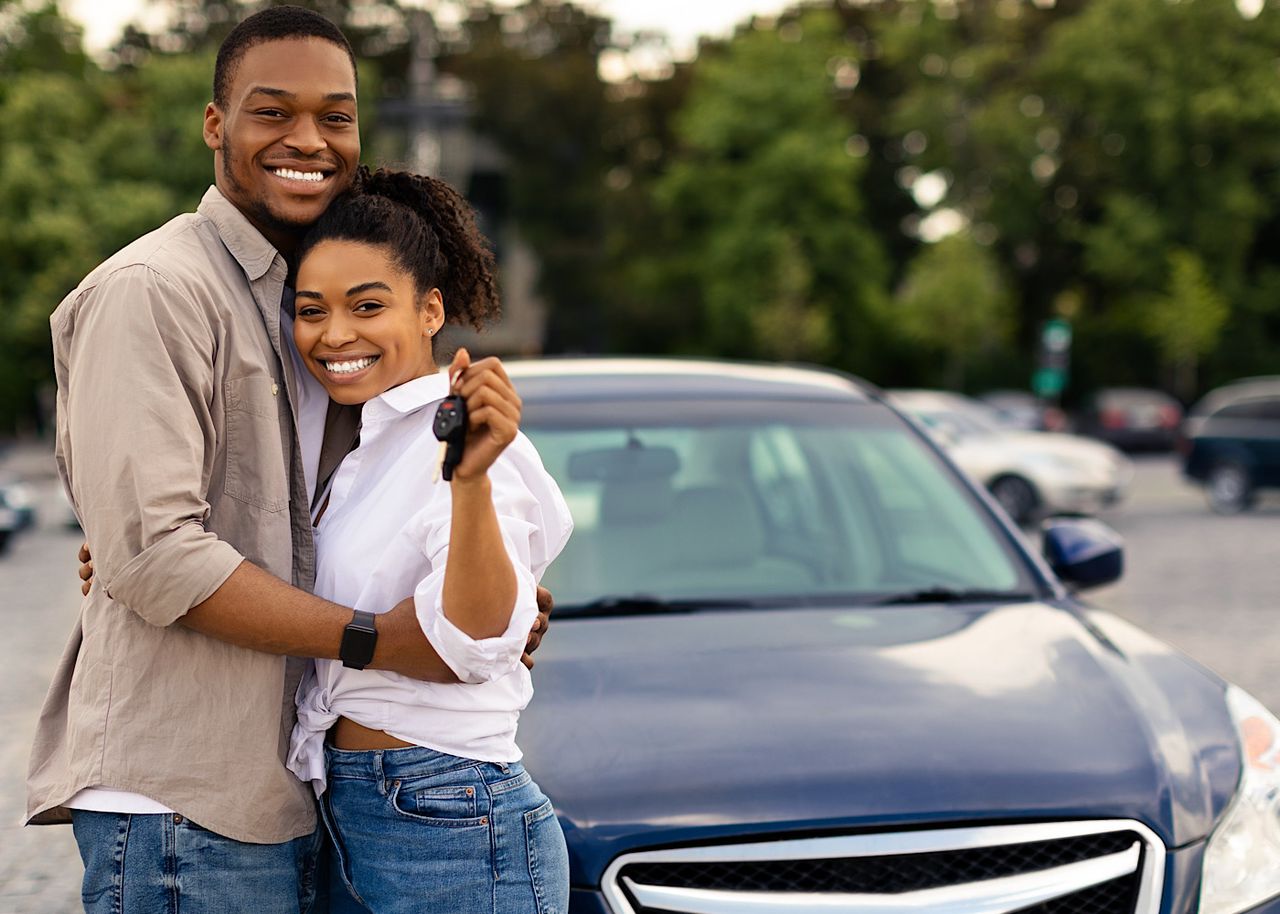Young romantic couple enjoying in their love in car trunk in nature. by drazenphoto