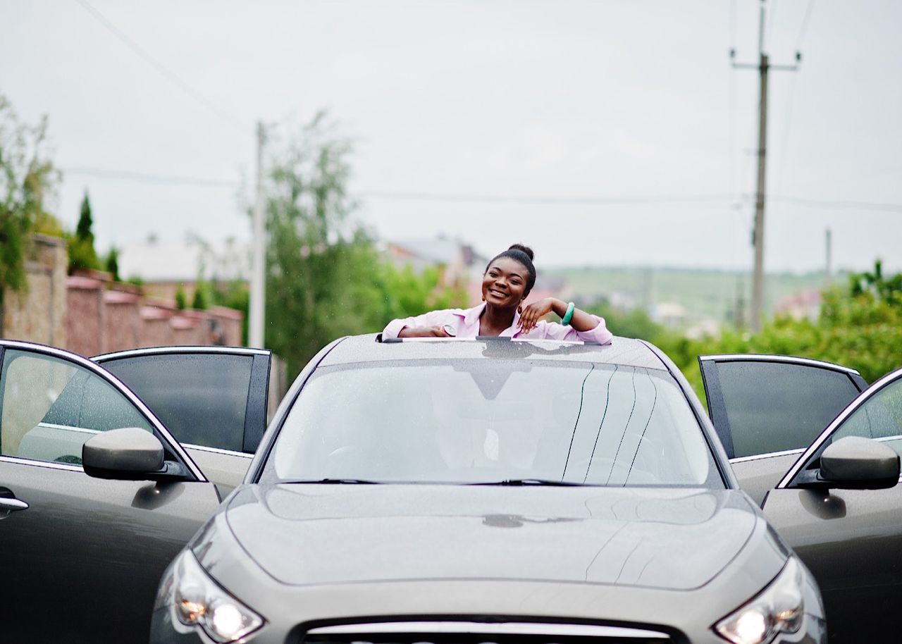 African businesswoman and car by ASphotostudio