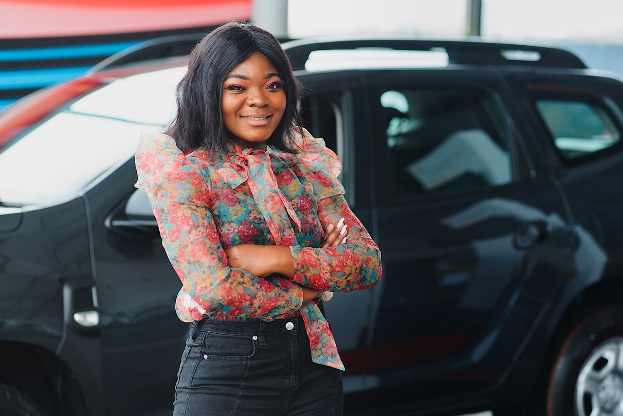 Women buying the car. Ladies in a car salon. Black girls near white car by sedrik2007